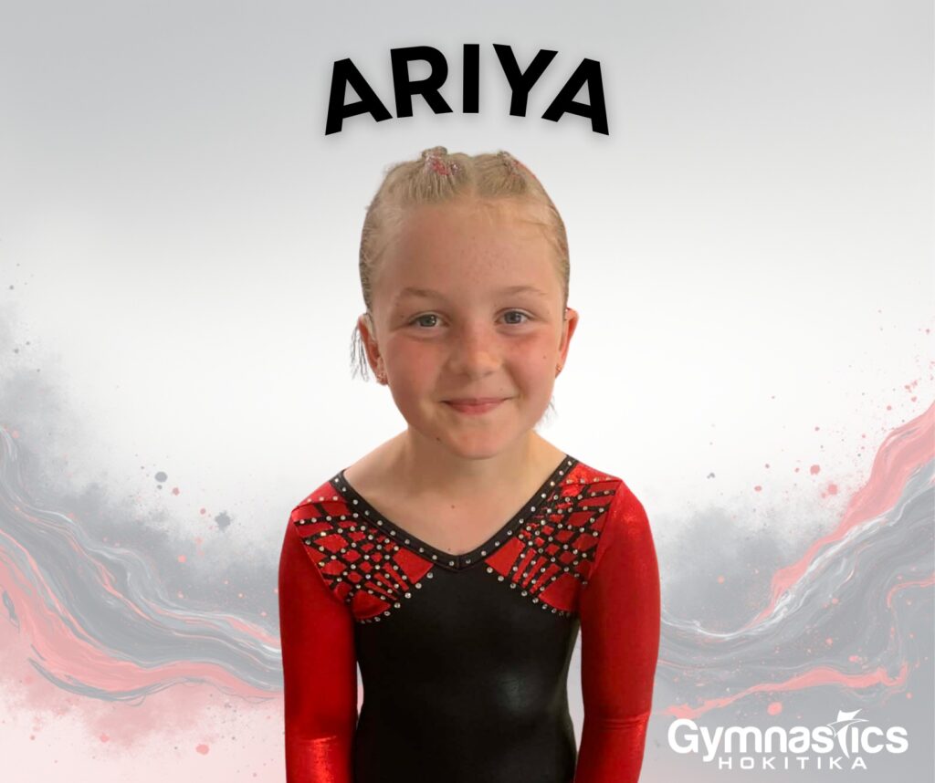 Young girl in a red and black gymnastics leotard smiles at the camera, with the name "Ariya" above her and a "Gymnastics Hokitika" logo in the corner.
